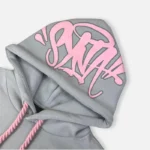 Chandal Synaworld ‘Syna Logo GrisRosa 2.webp